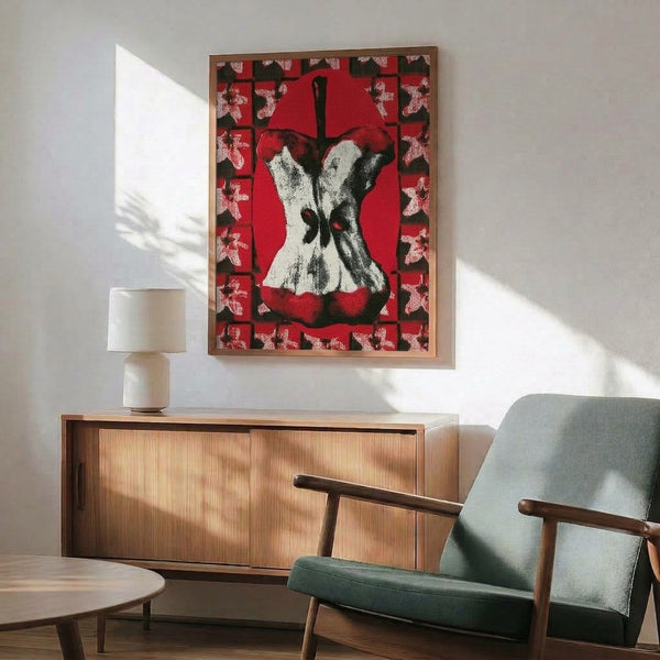 Edgy pop art interpretation of an apple core in striking red hues with minimalist black and cream accents, framed on a wall as modern statement art.