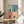 Cheerful black cat pop art framed poster split into four grid sections featuring a playful palette of sage green, slate blue, dusty rose, and warm peach tones.