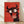 Bold pop art poster of a wide-eyed bull with exaggerated horns and expressive face in red, black, and cream tones framed on a wall.