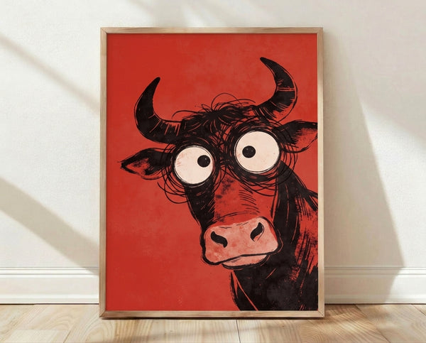 Bold pop art poster of a wide-eyed bull with exaggerated horns and expressive face in red, black, and cream tones framed on a wall.