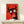 Playful bull art print with exaggerated features and contemporary pop art style in red, black, white, and cream hanging as wall décor.