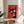 Vibrant pop art bull print with whimsical character and graphic line illustration in red, black, cream, and white framed for display.