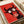 Modern poster art of a wide-eyed bull rendered in playful pop art style with bold black lines and striking red and cream coloring.