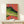 Psychedelic retro crocodile art print with striking geometric stripes in neon green, tangerine, and purple tones, mounted in a frame.