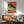 Retro-inspired crocodile wall art featuring bold psychedelic stripes in hot orange, lime green, and purple with black and tan accents, framed contemporary print.