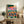 Modern abstract wall art depicting a whimsical elephant amid mountains and sky with kinetic satellite imagery, bursting with energetic hot pink and teal tones in contemporary pop art style.