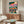 Contemporary pop art landscape poster with a fantastical elephant and satellite dish motif in bold hot pink, teal, and cream, capturing a whimsical, kinetic mood in modern abstract style.