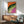 Vibrant modern pop art composition of an iguana in saturated orange, magenta, and lime green colors with bold black outlines, a trendy framed art print for walls.