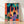Vibrant pop art poster of a jazz trumpeter in orange, turquoise, and navy tones with abstract architectural elements, framed on a wall.