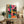 Modern pop art poster of musicians playing instruments rendered in dynamic abstract forms with striking hot pink, teal, yellow, and orange tones against black.