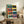 Retro-inspired grid pop art print of a classic Leica camera rendered in bold playful colors including teal, coral red, and yellow, displayed as framed wall art.