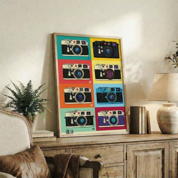 Retro-inspired grid pop art print of a classic Leica camera rendered in bold playful colors including teal, coral red, and yellow, displayed as framed wall art.