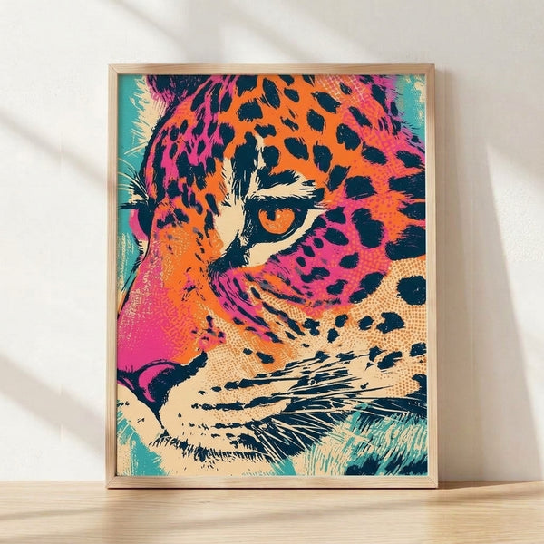 Bold pop art leopard portrait in vibrant turquoise, magenta, and orange tones with navy and cream accents, framed poster on wall.