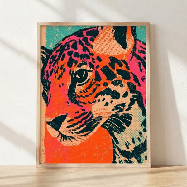 Bold pop art leopard portrait in hot pink, orange, and teal with black outlines, featuring a playful modern retro style framed poster on a wall.