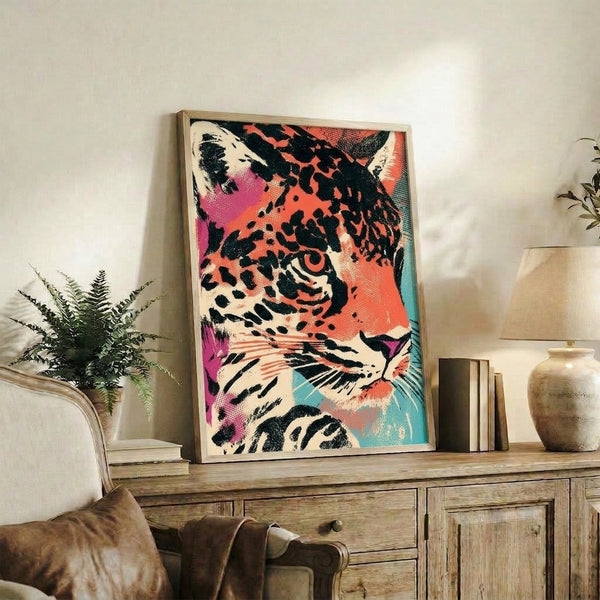 Playful leopard head rendered in bright pop art style using magenta, teal, and coral hues with black accents, displayed as a framed poster.