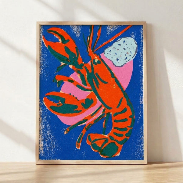 Bold pop art lobster print in royal blue, hot pink, and orange-red with forest green accents, displayed as a framed poster on a wall.
