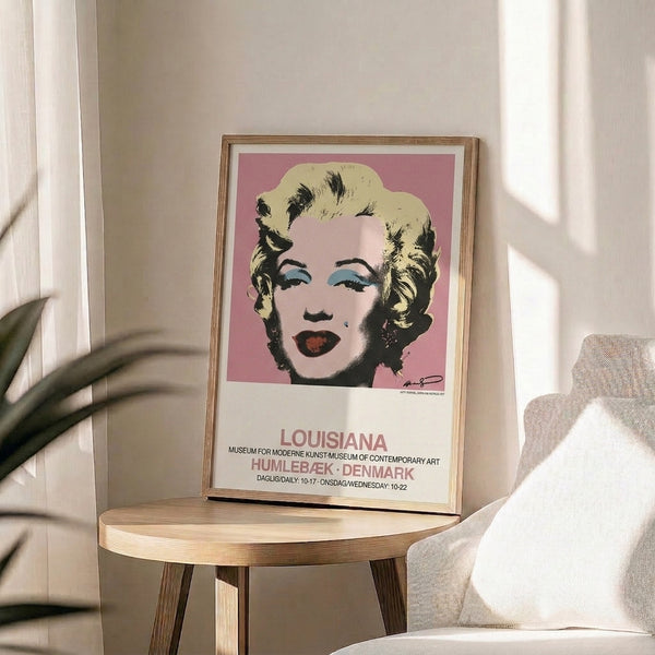 Pop art style portrait print with bold color contrasts in pink, cream, and black, rendered in the distinctive minimalist approach of contemporary visual art.