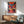 Modern pop art bird portrait showcasing a stylized owl in striking red, coral, and navy blue hues with gold accents, framed wall art.