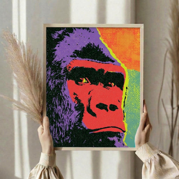 Vibrant gorilla face artwork in striking pop art style with purple, red, and yellow hues, displayed as a framed poster.