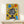 Funky framed artwork showcasing a dotted robot portrait with crown and audio equipment motifs, bursting with playful pop art aesthetics in vibrant yellow, black, and electric blue.