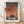 Framed poster of a red seaplane flying over an castle and water under a dramatic sunset sky in rust orange, teal, and golden hues.