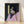 Framed abstract portrait painting in dark tones showing a seated figure rendered in loose, expressive brushstrokes characteristic of mid-20th century modern art.