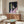 Framed contemporary portrait artwork with a contemplative mood, rendered through loose, layered brushwork in a restrained dark palette on a gallery-style wall display.