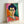 Framed abstract portrait print showing a stylized female face with an iconic green stripe, blending soft watercolor technique with vibrant color blocking in warm and cool hues.