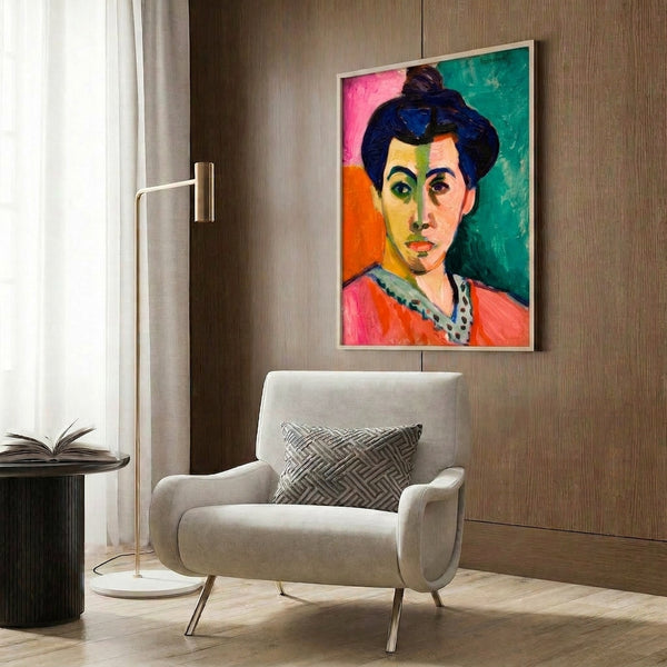 Framed contemporary portrait artwork depicting a serene female face marked by a bold emerald-green stripe, rendered in soft watercolor with warm peachy and cream accents.