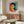 Wall-mounted art print depicting a woman's portrait through fluid, colorful abstraction with dominant greens, reds, and blues.