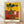 Abstract surreal portrait with whimsical distorted features in vivid reds, blues, yellows, and earth tones, framed on a wall.