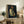 Portrait painting of a contemplative figure in soft earth tones and pale blues, rendered in Cezanne's structured post-impressionist approach.