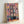 Japandi-inspired framed poster of organized potted flowers and greenery in a grid composition, combining Bauhaus design principles with warm pink, yellow, and cool teal tones.