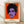 Bold pop art portrait of Prince in vibrant magenta, electric blue, and yellow with black outlines, framed on a wall as a modern art print.