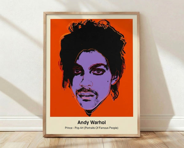Bold pop art portrait of Prince in vibrant magenta, electric blue, and yellow with black outlines, framed on a wall as a modern art print.