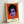 Pop art portrait of Prince rendered in striking magenta and electric blue with bold graphic elements, shown framed as contemporary wall art.