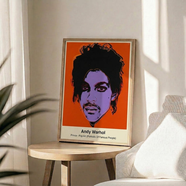 Colorful celebrity portrait in pop art style featuring Prince with bold black outlines and neon magenta, blue, and yellow hues, framed on wall.