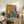 Abstract wall print featuring a purple-robed figure amid energetic, colorful anemone blossoms rendered in expressive, fluid brushwork.