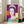 Vibrant pop art interpretation of Queen Elizabeth II with luminous colors and bold outlines, presented as a contemporary art print in a frame.
