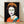 Pop art portrait of Queen Elizabeth II in bold black and jewel tones, framed on a wall as a modern art print inspired by the Reigning Queens series.
