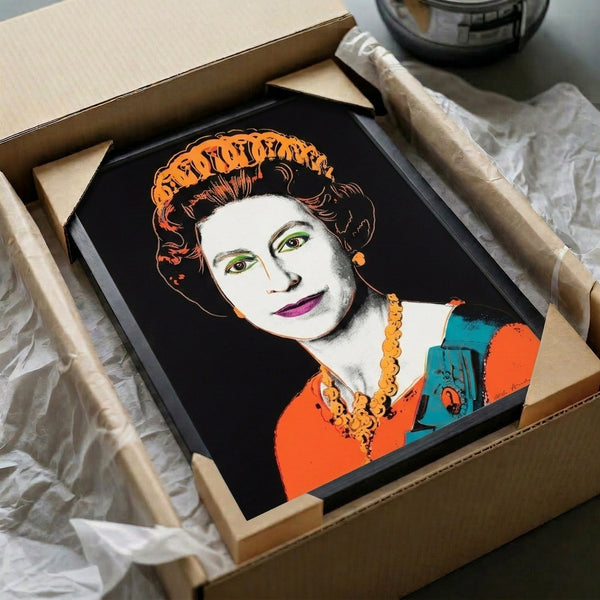 Framed pop art print depicting Queen Elizabeth II in expressive, colorful graphic style from the iconic Reigning Queens series for modern interiors.