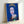 Vibrant pop art interpretation of Queen Elizabeth II using electric blue palette and graphic silkscreen-style technique, creating a bold statement piece for modern interior spaces.