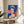 Vibrant blue-toned pop art portrait of Queen Elizabeth II with stylized, minimalist facial features and high-contrast graphic composition from the famous Reigning Queens series.