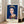 Contemporary art print on wall showing a stylized portrait in dark blue and white, exemplifying pop art aesthetics with regal, iconic mood.