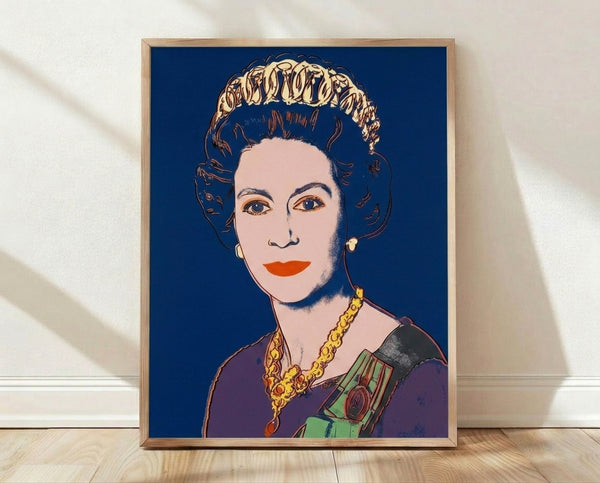Pop art portrait of Queen Elizabeth II in bold dark blue tones, featuring stylized facial features and vibrant color blocking in the Reigning Queens series style, framed poster on wall.