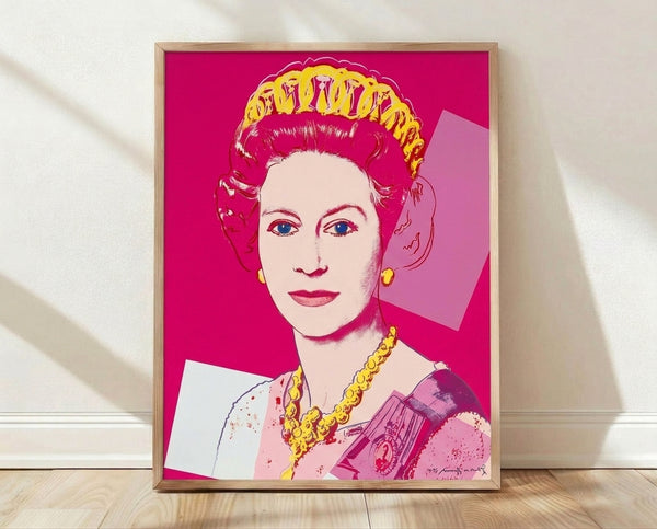 Pop art portrait of Queen Elizabeth II in vibrant pink tones, inspired by Andy Warhol's Reigning Queens series, displayed as a framed poster on a wall.