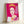 Framed pop art print of Queen Elizabeth II rendered in bright pink and complementary colors, exemplifying Warhol's famous repetition and bold color techniques.