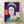 Pop art portrait of Queen Elizabeth II in vibrant purple tones, framed on a wall as a modern art print inspired by the Reigning Queens series.