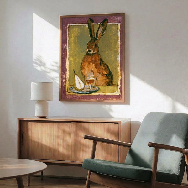 Gentle watercolor painting of a rabbit with wine and fruit in earthy mauve, gold, and cream hues, capturing countryside whimsy in folk art style as a framed wall print.