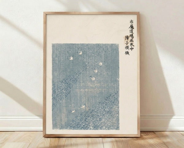 Framed Japanese woodblock print of cranes in a misty landscape with slate blue and gray tones, evoking serene tranquility.
